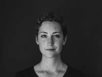 grayscale photo of woman wearing necklace and top