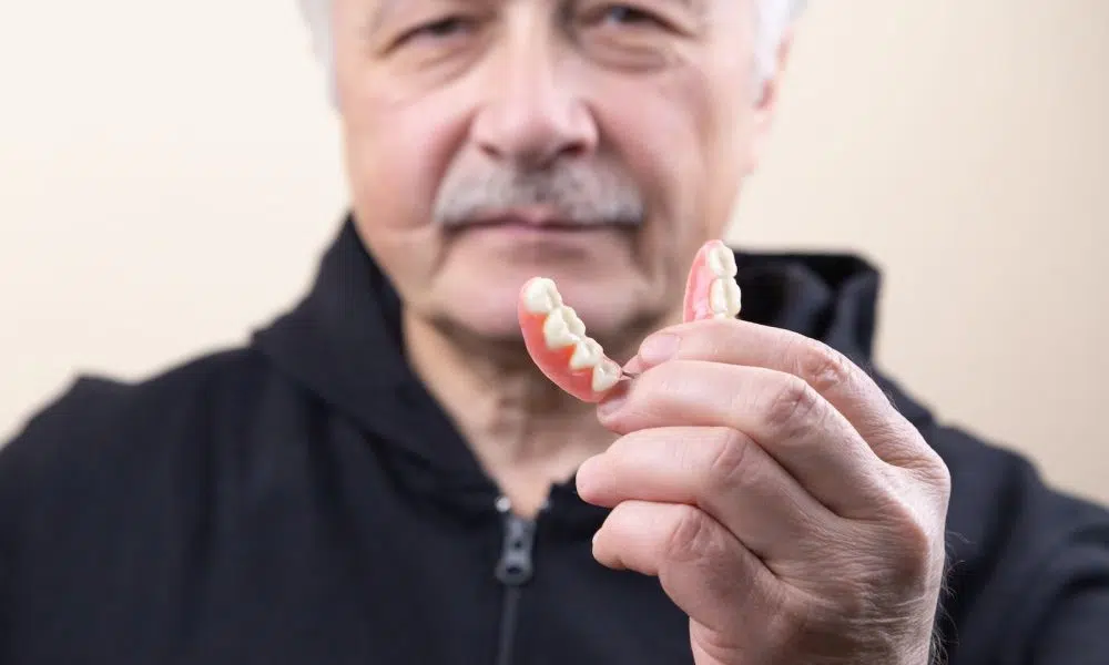 man in black shirt holding white candy