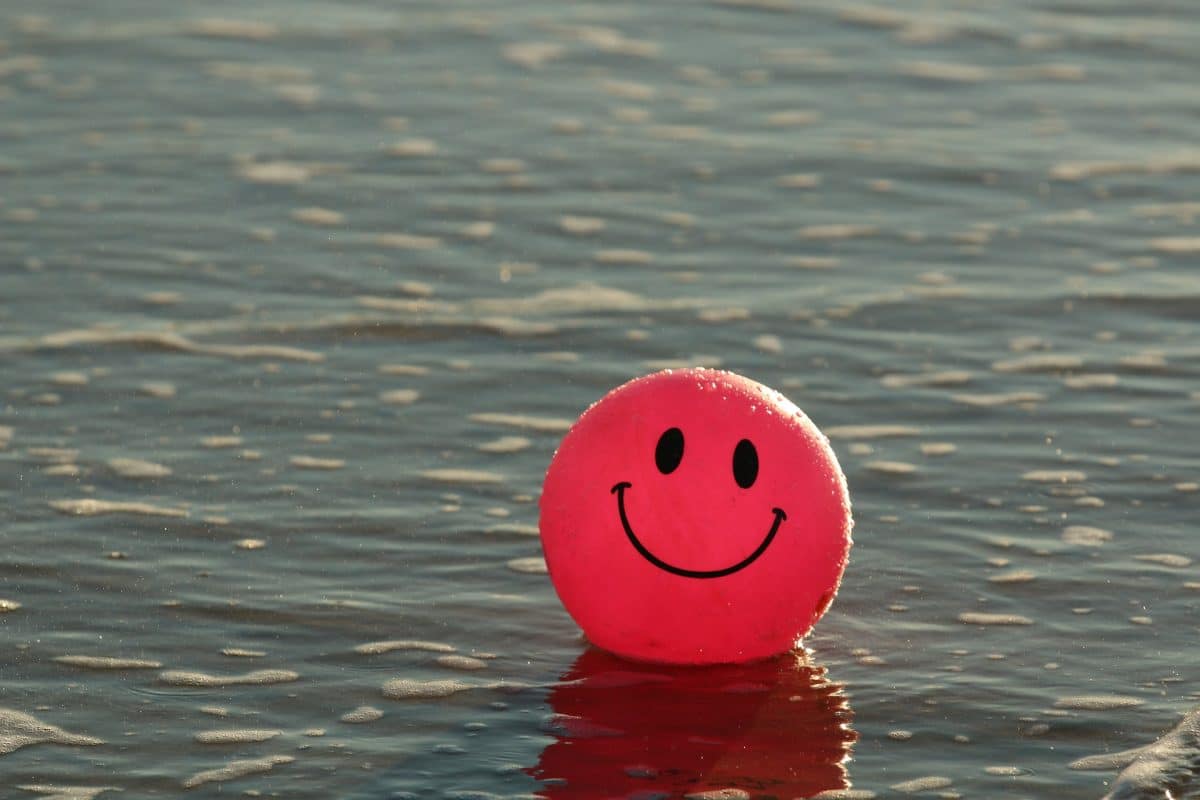 Un ballon emoji souriant dans l'eau