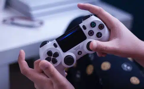 person holding white and black game controller